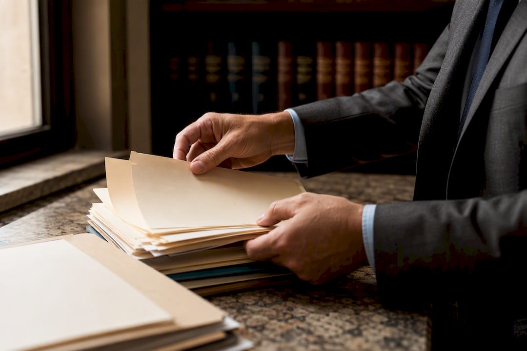 Driving While License Suspended Florida: Rules and Defenses Hands opening legal case files envelope