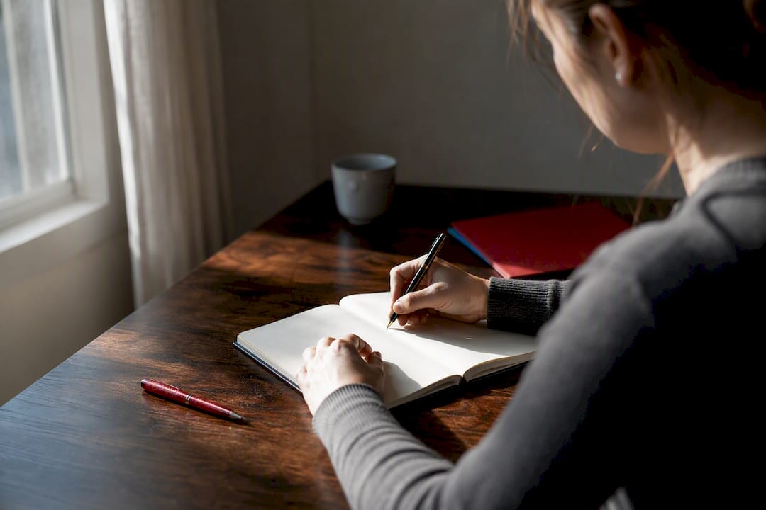 Hands writing a private incident log
