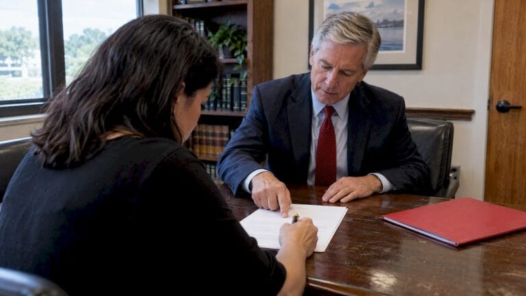 Client reviews fee agreement before signing
